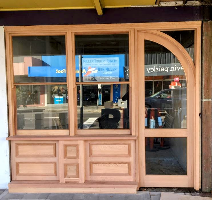 Timber shopfront with arched highlight and panelled base